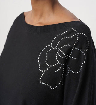 Close-up of sparkling flower appliqué on Joseph Ribkoff black pullover shoulder